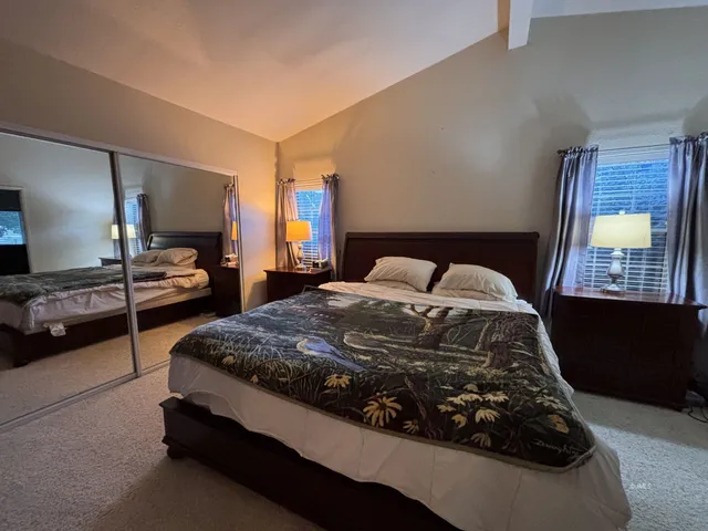 a bedroom with a bed and window