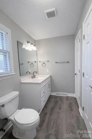 a bathroom with a double vanity sink toilet and shower
