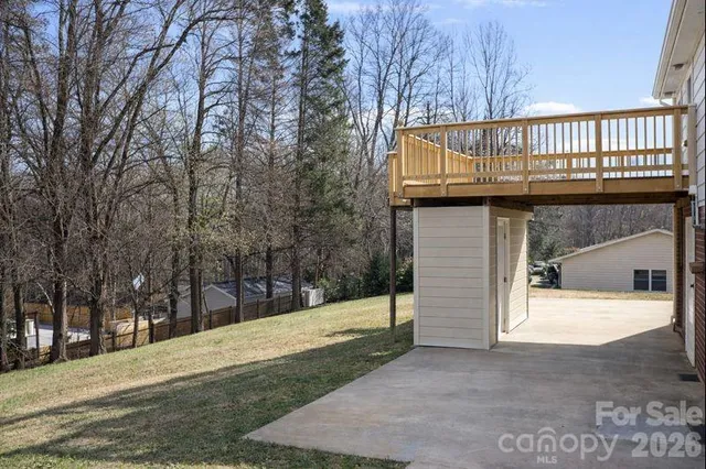 a view of a house with a wooden fence