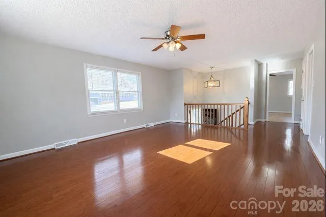 a view of a livingroom with a furniture wooden floor and a chandelier