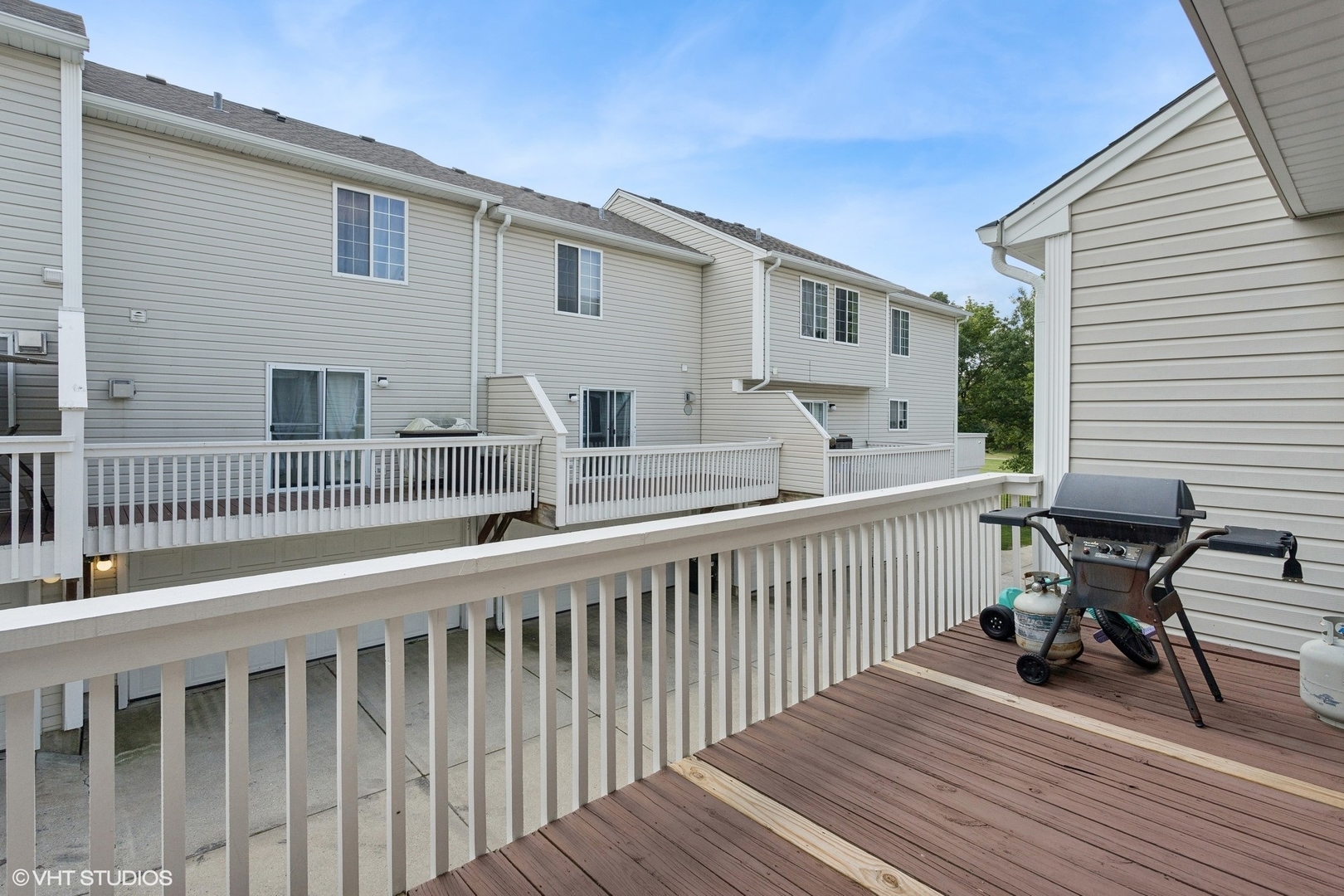 33 South Treehouse Lane Round Lake, IL 60073 - Photo 5 of 10 a view of a house with wooden deck and furniture