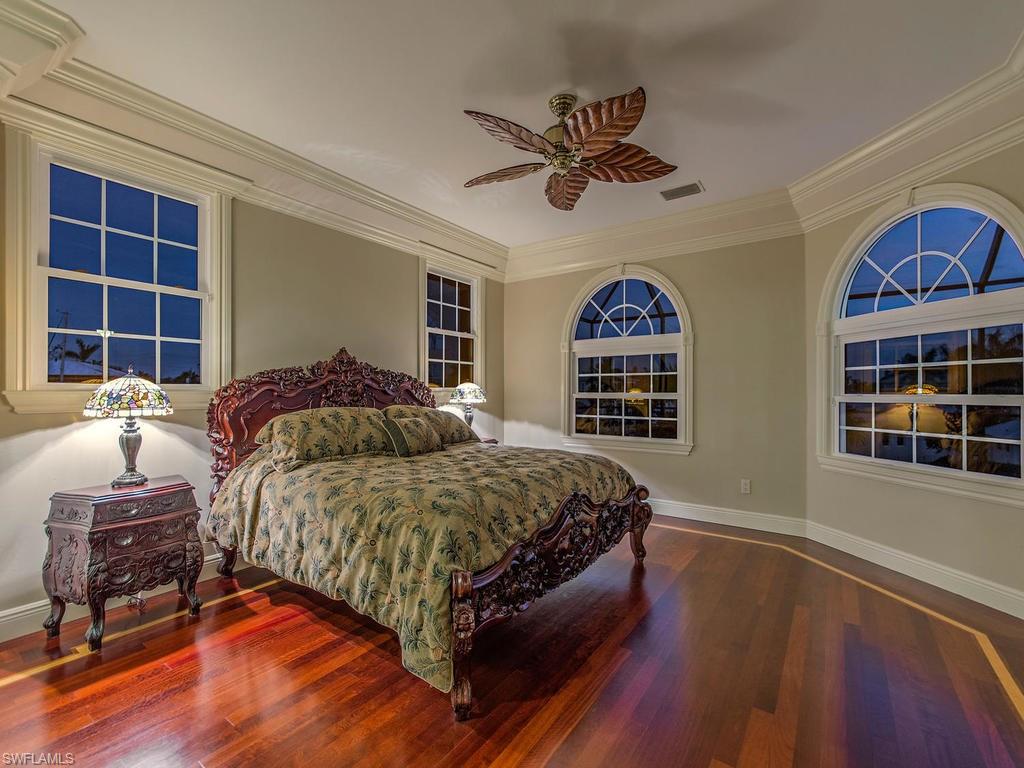 1835 Kingfish Road Naples, FL 34102 - Photo 12 of 23 a spacious bedroom with a bed and a window