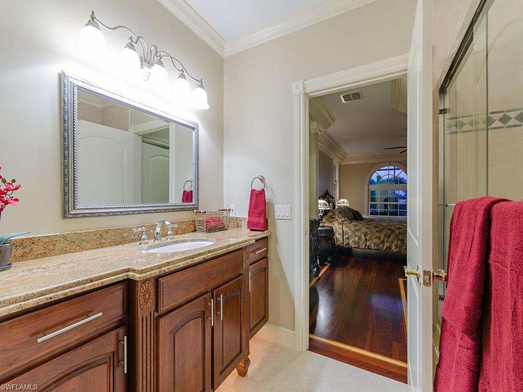 1835 Kingfish Road Naples, FL 34102 - Photo 13 of 23 a en suite bathroom with a sink vanity and a mirror