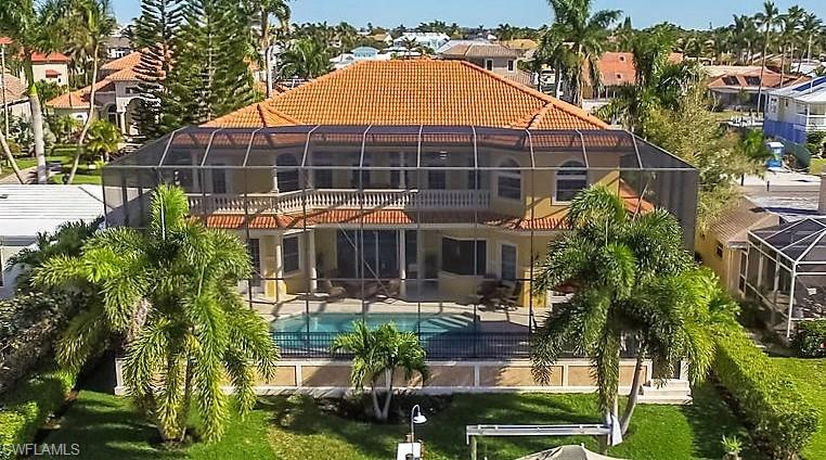 1835 Kingfish Road Naples, FL 34102 - Photo 2 of 23 a view of a house with pool and sitting area