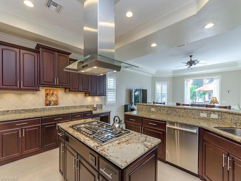 1835 Kingfish Road Naples, FL 34102 - Photo 5 of 23 a kitchen with stainless steel appliances granite countertop stove top oven a sink and dishwasher