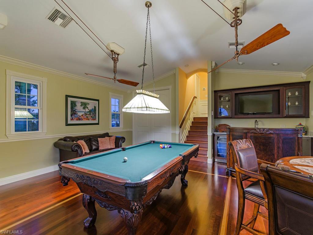 1835 Kingfish Road Naples, FL 34102 - Photo 9 of 23 a living room with pool table and a flat screen tv