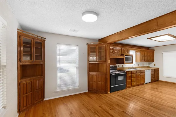 a kitchen with stainless steel appliances granite countertop a refrigerator and a stove top oven