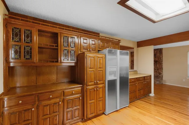 a kitchen with stainless steel appliances granite countertop a refrigerator and cabinets