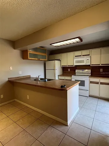 a kitchen with a sink and a refrigerator