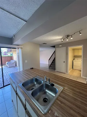 a kitchen with a stove a sink and a microwave