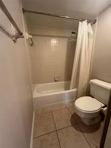 a bathroom with a sink a toilet and a large mirror