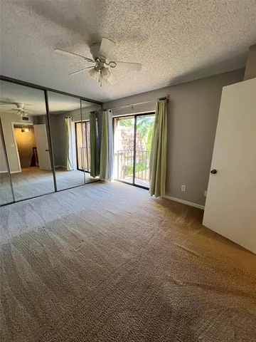 a view of an empty room with a fireplace and a window