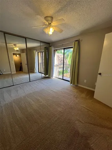 a view of a livingroom with a ceiling fan and window