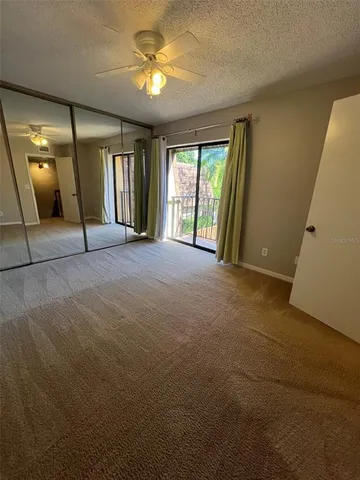 an empty room with a fan and a fan