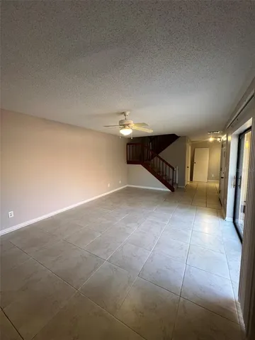 a view of a livingroom with furniture and chandelier fan