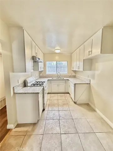 a view of an empty room and wooden floor