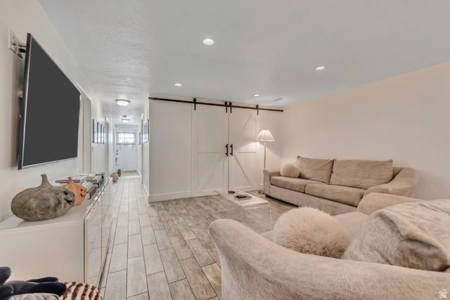 1071 Jamie-Matt Circle Layton, UT 84041 - Photo 1 of 28 Living area with a barn door, wood finish floors, and recessed lighting