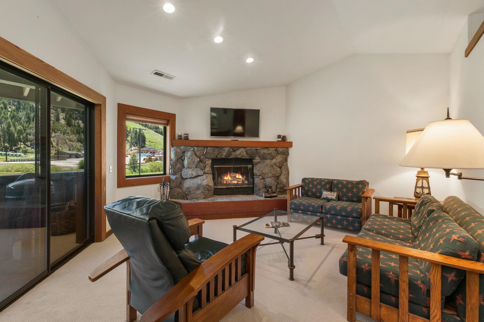 1591 Olympic Vly Road, Unit 29 Olympic Valley, CA 96146 - Photo 2 of 28 a living room with furniture and a fireplace