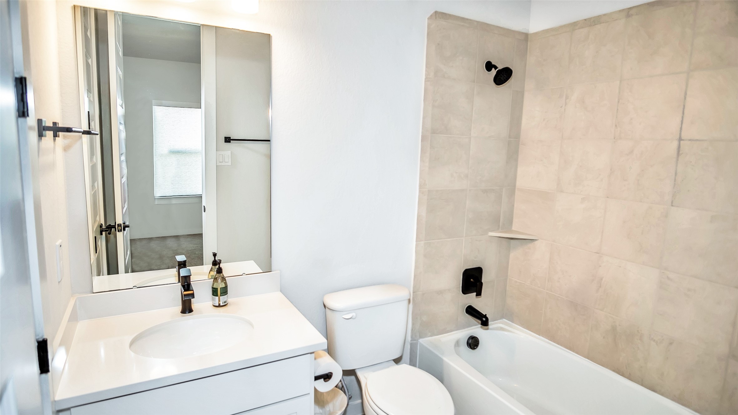 1919 Pueblo Nuevo Path Houston, TX 77077 - Photo 20 of 50 a bathroom with a sink a toilet and shower curtain