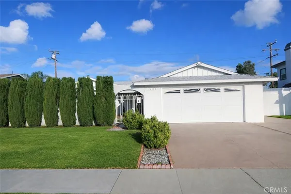 a view of a house with a garden and yard