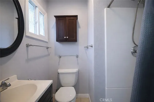 a white toilet sitting next to a bathroom sink