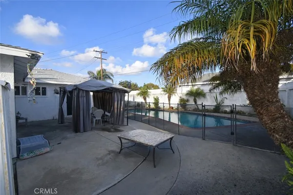 a view of a patio with a table and chairs