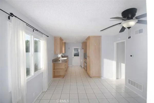 a view of a kitchen with a refrigerator and cabinets