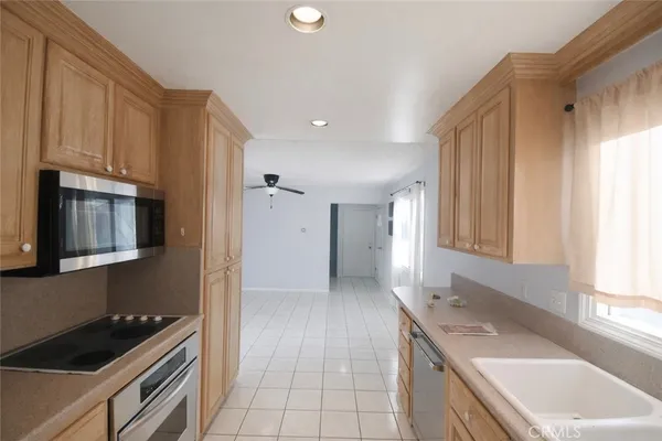 a kitchen with granite countertop a sink stove and cabinets