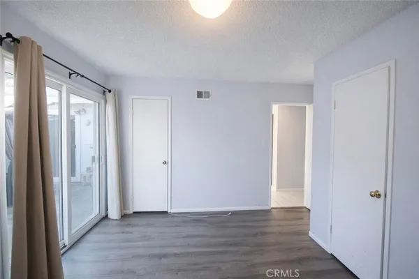 a view of wooden floor and windows in a room