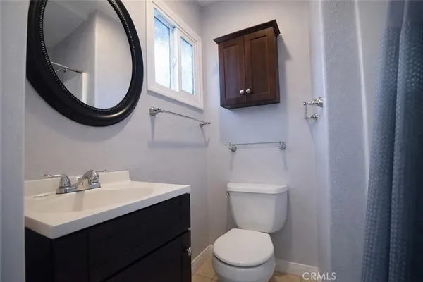 a bathroom with a toilet a sink and a mirror