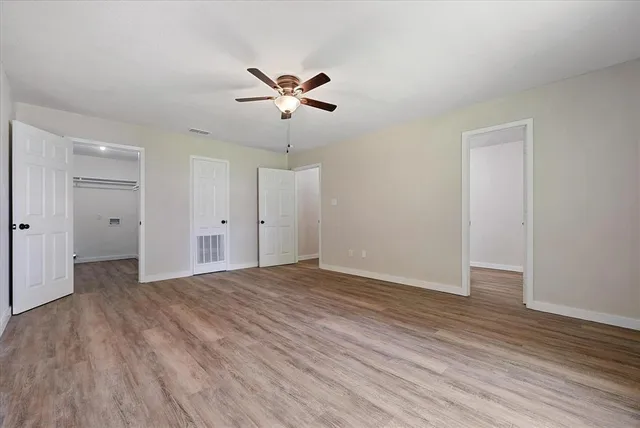 a view of an empty room with wooden floor