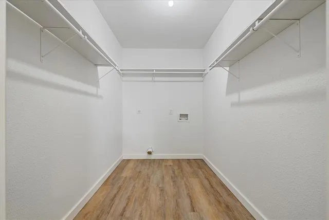 a view of a room with wooden floor
