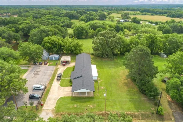 an aerial view of residential houses with outdoor space and swimming pool