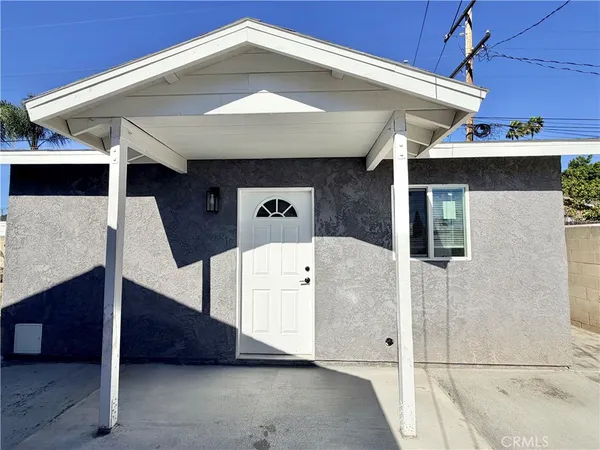 a roof deck with table and chairs