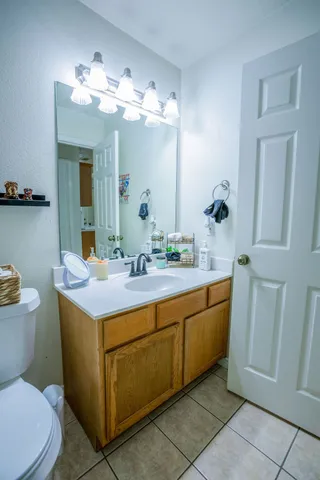 a bathroom with a toilet sink and mirror