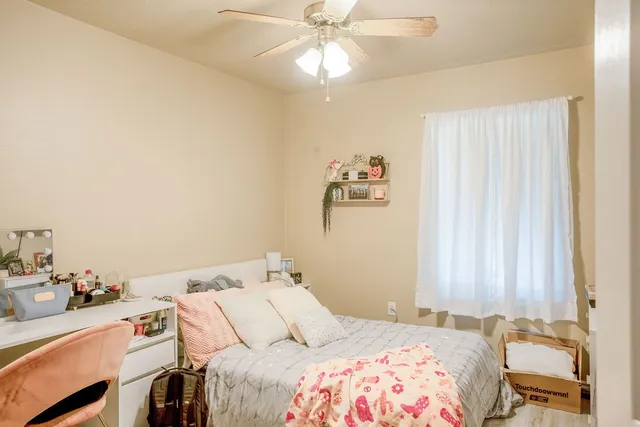 a bedroom with a bed and a chandelier