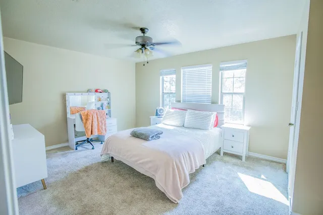 a bedroom with a bed and a chandelier