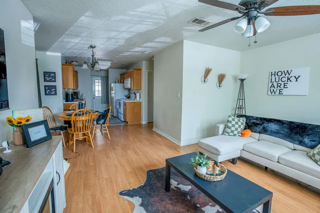 a living room with furniture and wooden floor