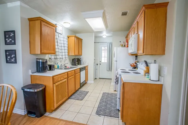 a kitchen with stainless steel appliances granite countertop a sink and a refrigerator