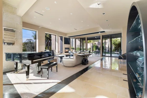 a living room with furniture a large window and a table