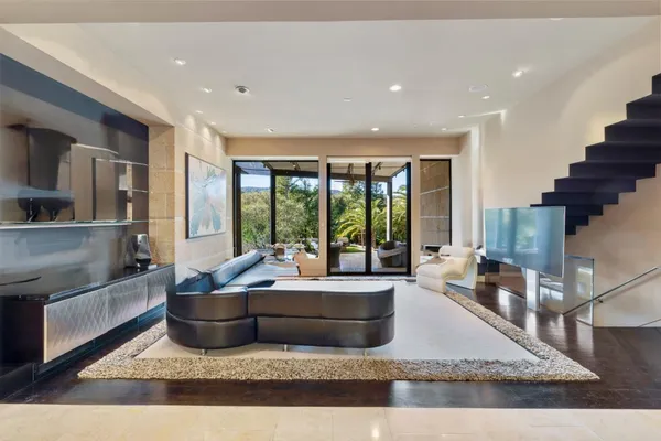 a living room with furniture and a potted plant