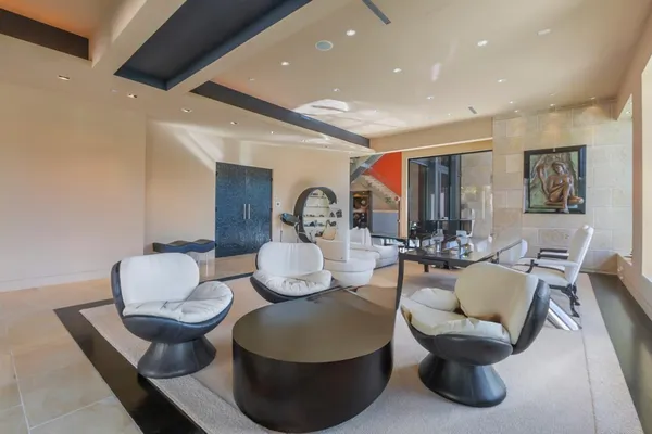 a living room with furniture and a potted plant