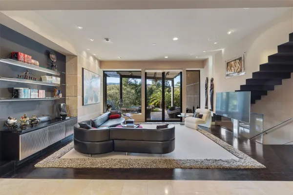 a living room with furniture and a floor to ceiling window