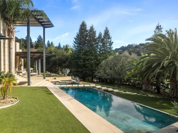 a view of a swimming pool and lounge chairs