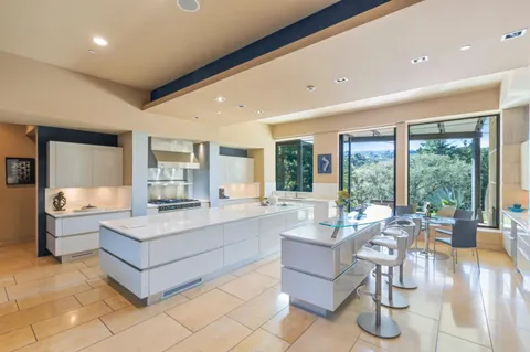 a kitchen with stainless steel appliances kitchen island granite countertop a sink and cabinets