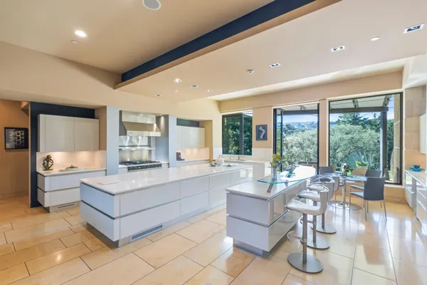 a kitchen with stainless steel appliances kitchen island granite countertop a sink and cabinets