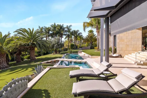 a view of a swimming pool with a lounge chairs