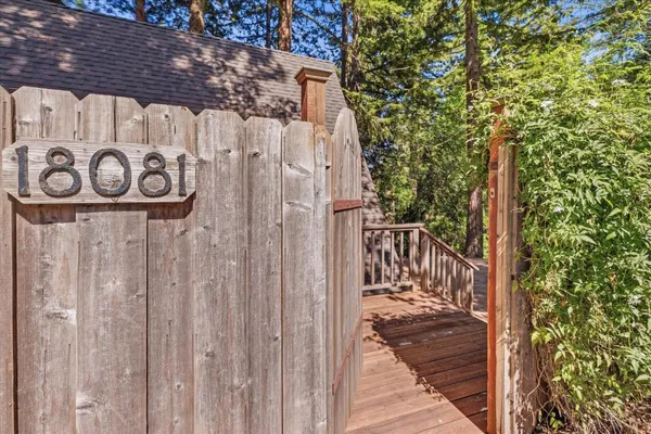 a view of backyard with deck and outdoor seating