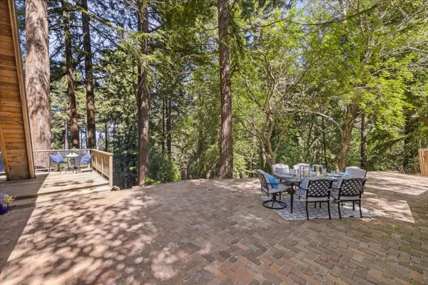 a view of a house with backyard and sitting area
