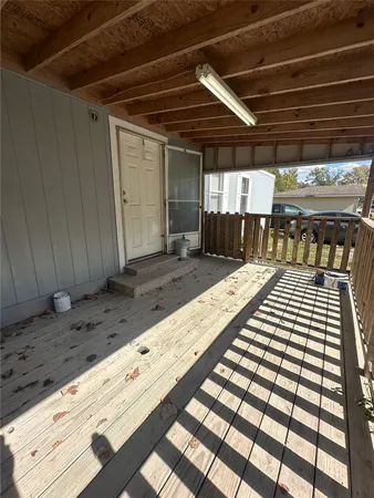 a view of a dry yard with wooden fence
